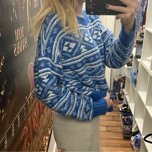 This is a blue and white festive knit sweater - American Eagle - size Medium